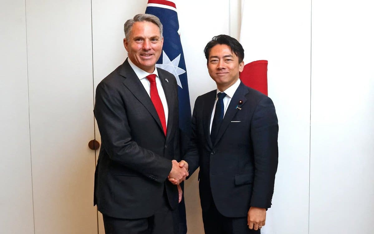 Australian deputy prime minister richard marles shakes hands with japanese defence minister shinjiro koizumi.