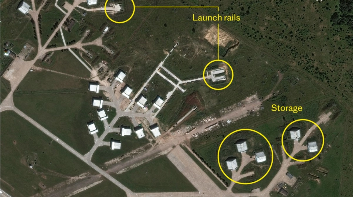 Satellite imagery of kurks-vostochny air base in russia, with callouts denoting drone launch rails and storage sites.