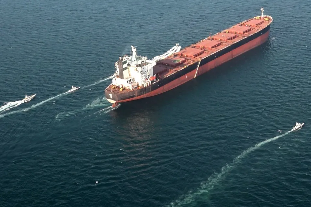 Boats manoeuvre around a tanker during iranian military exercises in the strait of hormuz on february 17, 2026