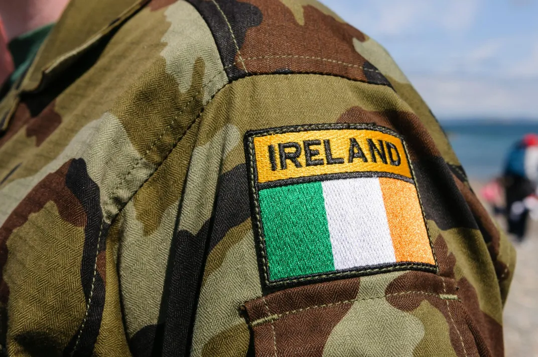 A shoulder patch of a soldier indicating "ireland" with the irish flag below.